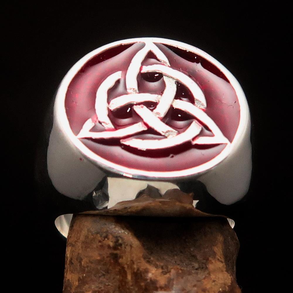 Men's Triquetra Ring featuring a Celtic Triskelion Knot design in solid sterling silver with red enamel accents, showcasing intricate craftsmanship.