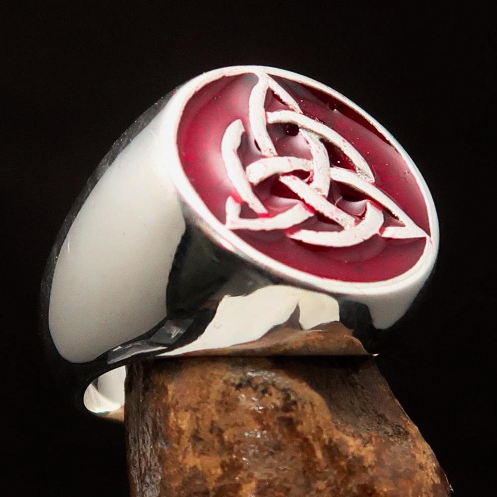 Men's Triquetra Ring featuring a Celtic Triskelion Knot design in solid sterling silver with red enamel accents, showcasing intricate craftsmanship.