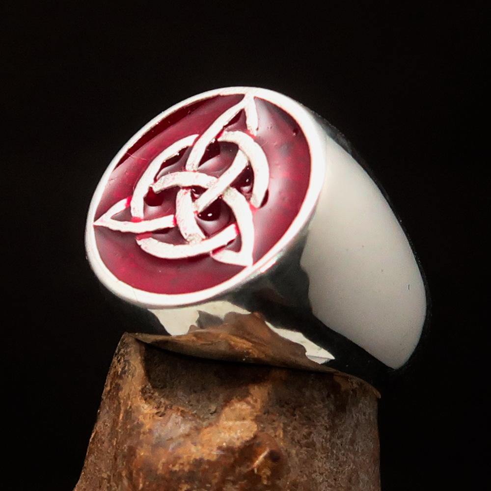 Men's Triquetra Ring featuring a Celtic Triskelion Knot design in solid sterling silver with red enamel accents, showcasing intricate craftsmanship.