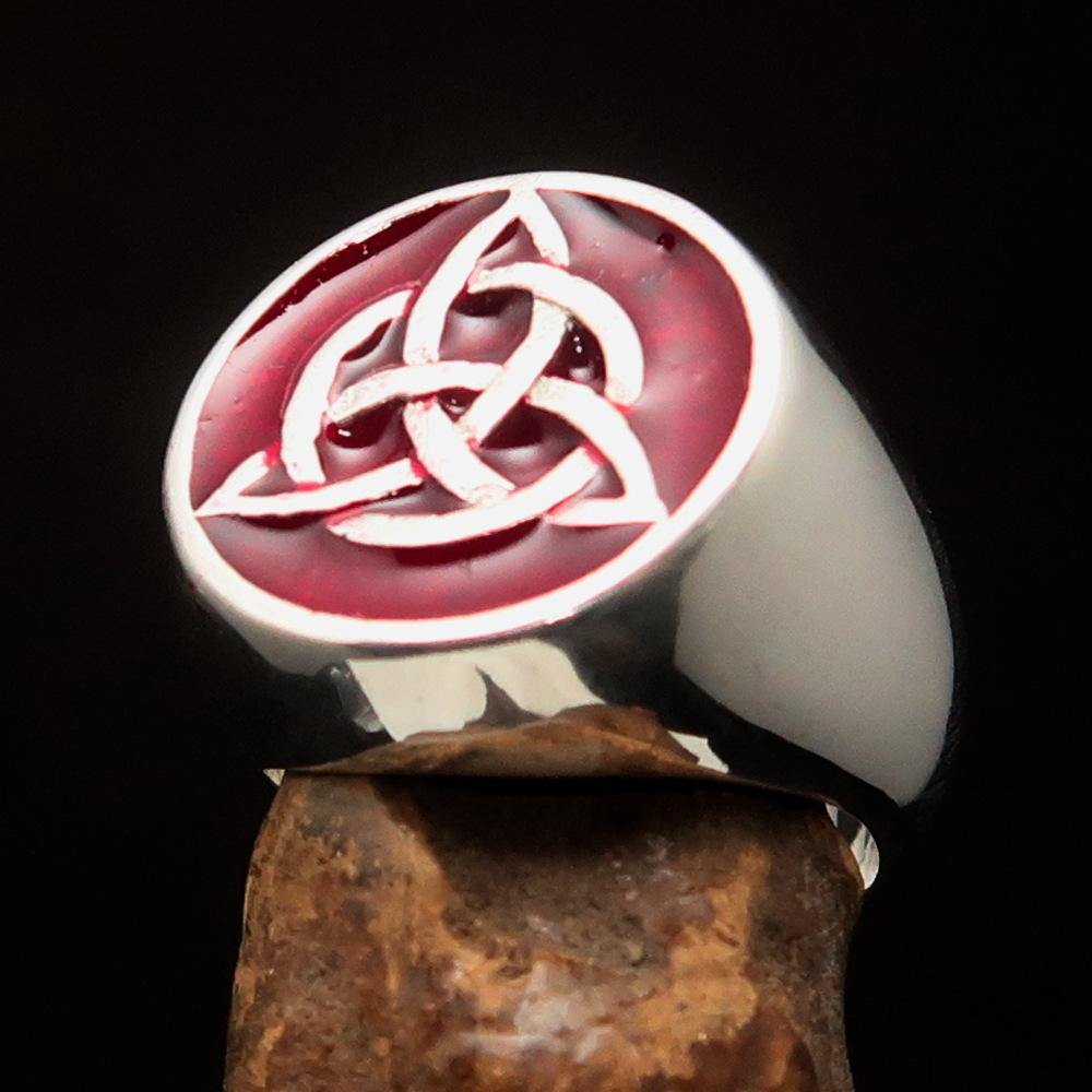 Men's Triquetra Ring featuring a Celtic Triskelion Knot design in solid sterling silver with red enamel accents, showcasing intricate craftsmanship.