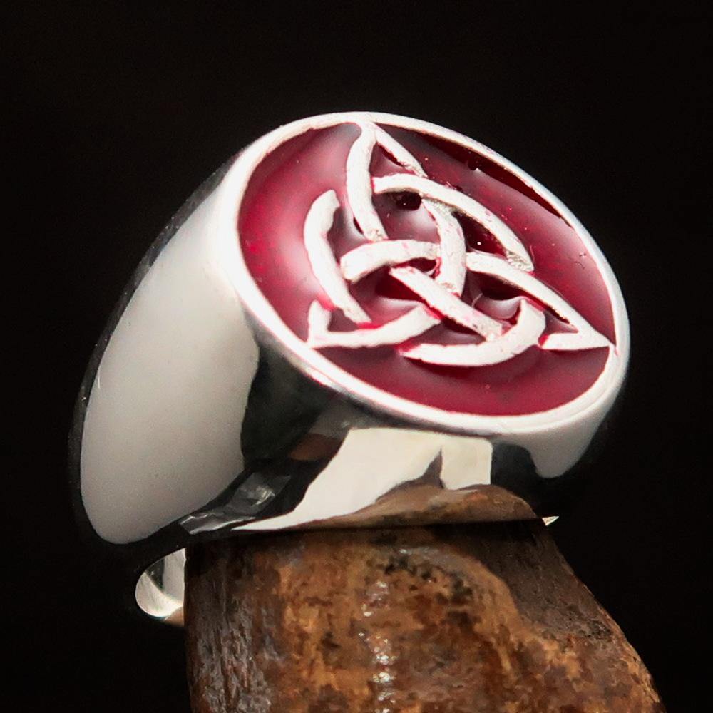 Men's Triquetra Ring featuring a Celtic Triskelion Knot design in solid sterling silver with red enamel accents, showcasing intricate craftsmanship.