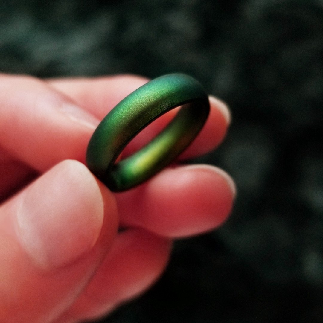 Northern Lights Green Breathable Silicone Ring showcasing its sleek bevel design and comfortable fit, suitable for both men and women.