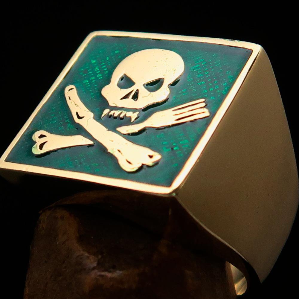 Men's Chef Skull Ring featuring crossed fork and knife design with green enamel finish, crafted from solid brass.