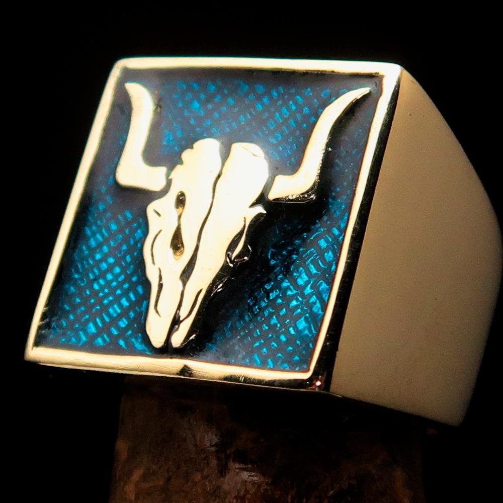 Men's Cowboy Ring featuring a bull skull design in solid brass with blue enamel accents, showcasing intricate details and a polished finish.