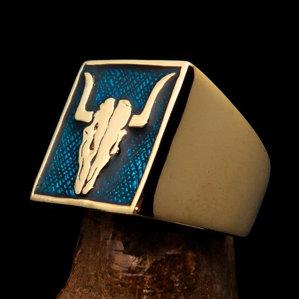 Men's Cowboy Ring featuring a bull skull design in solid brass with blue enamel accents, showcasing intricate details and a polished finish.