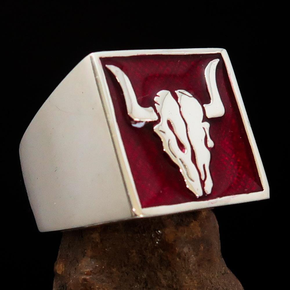 Men's Cowboy Ring featuring a detailed bull skull design in high polished sterling silver with red enamel accents.