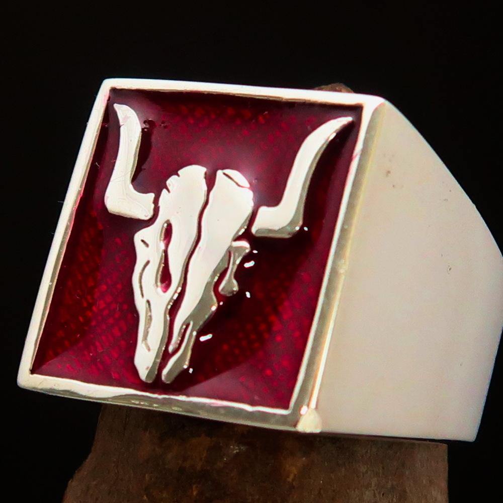 Men's Cowboy Ring featuring a detailed bull skull design in high polished sterling silver with red enamel accents.