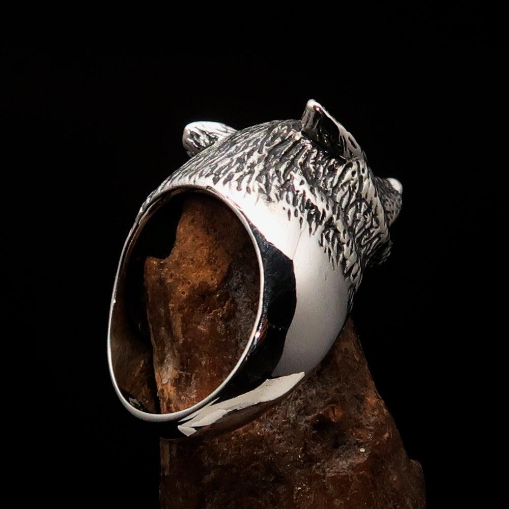 Men's howling wolf ring made of antiqued sterling silver, showcasing intricate detailing and a polished finish.