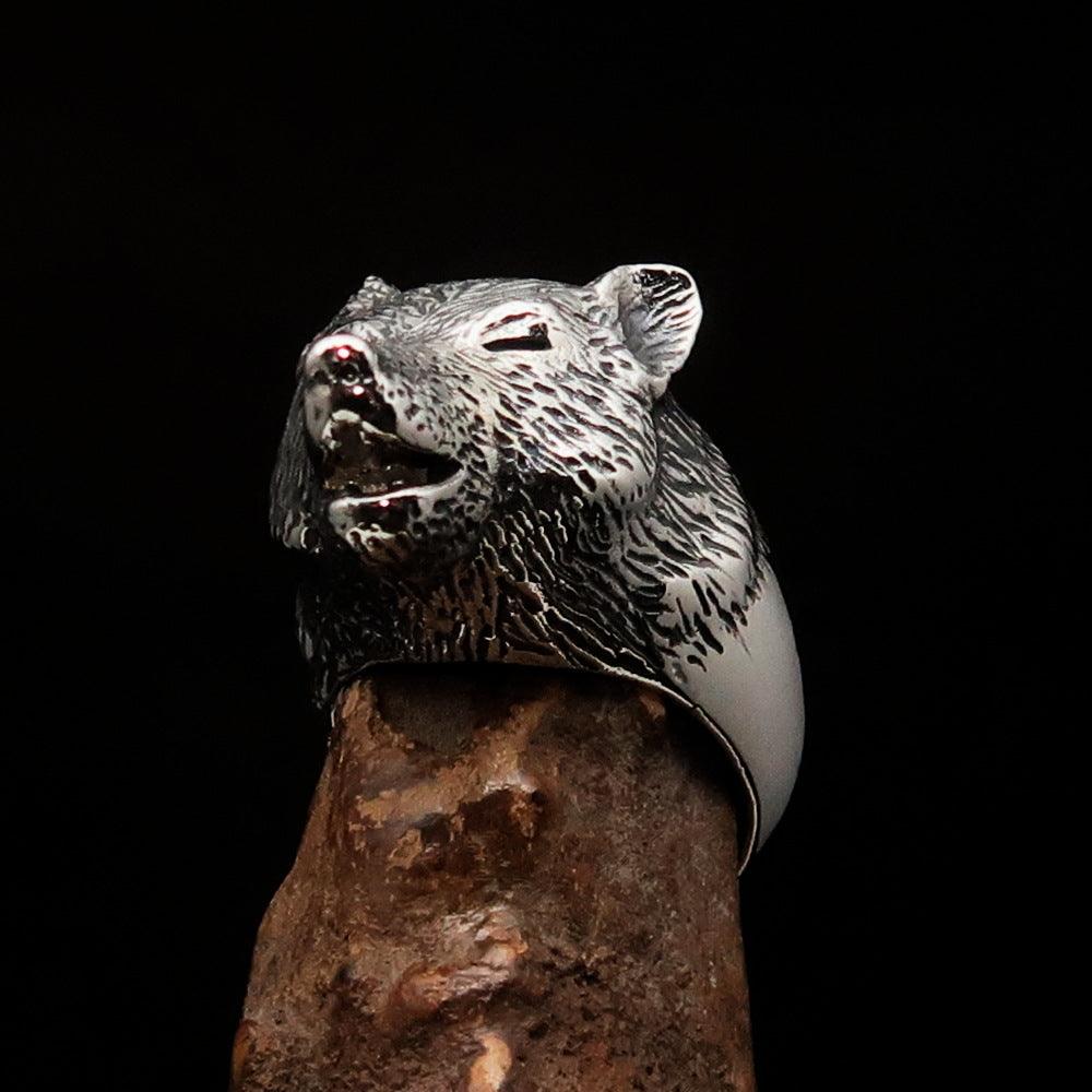 Men's howling wolf ring made of antiqued sterling silver, showcasing intricate detailing and a polished finish.