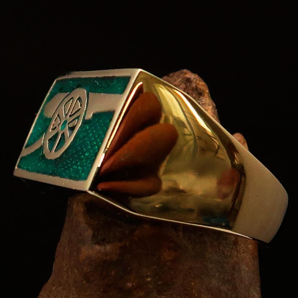 Men's Naval Cannon Ring made of solid brass with a high-polished finish and vibrant green enamel, showcasing its unique design and craftsmanship.