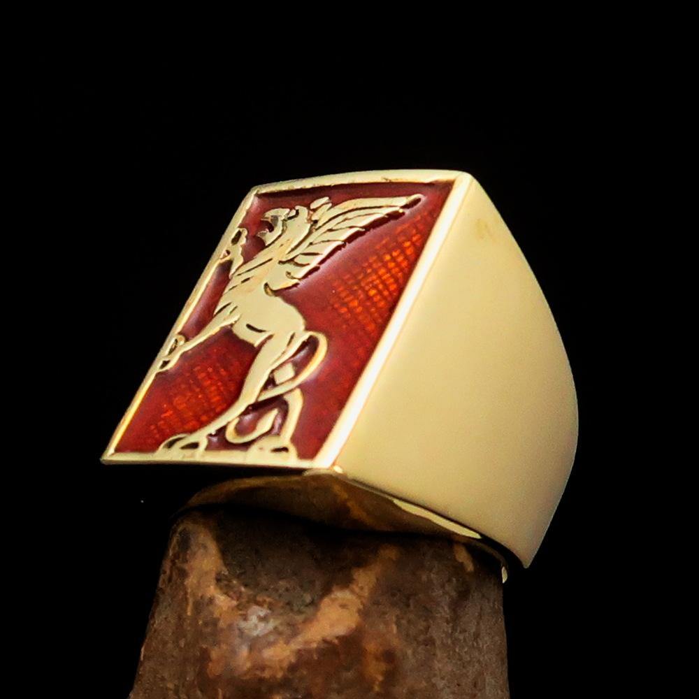 Men's Orange Griffin Ring made of solid brass with vibrant orange enamel, showcasing a polished finish and griffin design.