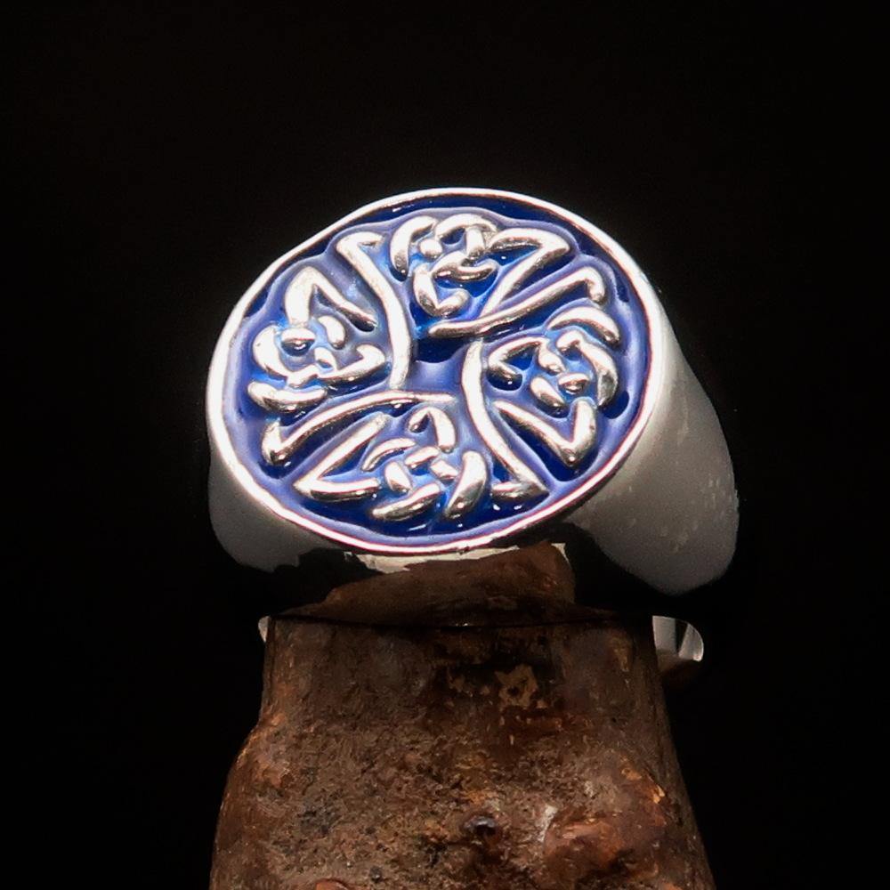 Men's sterling silver ring featuring Celtic Birgit's Cross design with blue enamel, showcasing intricate craftsmanship and high polish.