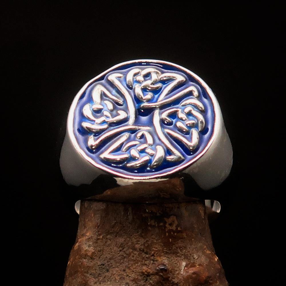 Men's sterling silver ring featuring Celtic Birgit's Cross design with blue enamel, showcasing intricate craftsmanship and high polish.