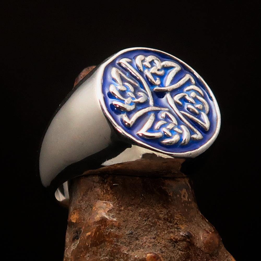 Men's sterling silver ring featuring Celtic Birgit's Cross design with blue enamel, showcasing intricate craftsmanship and high polish.