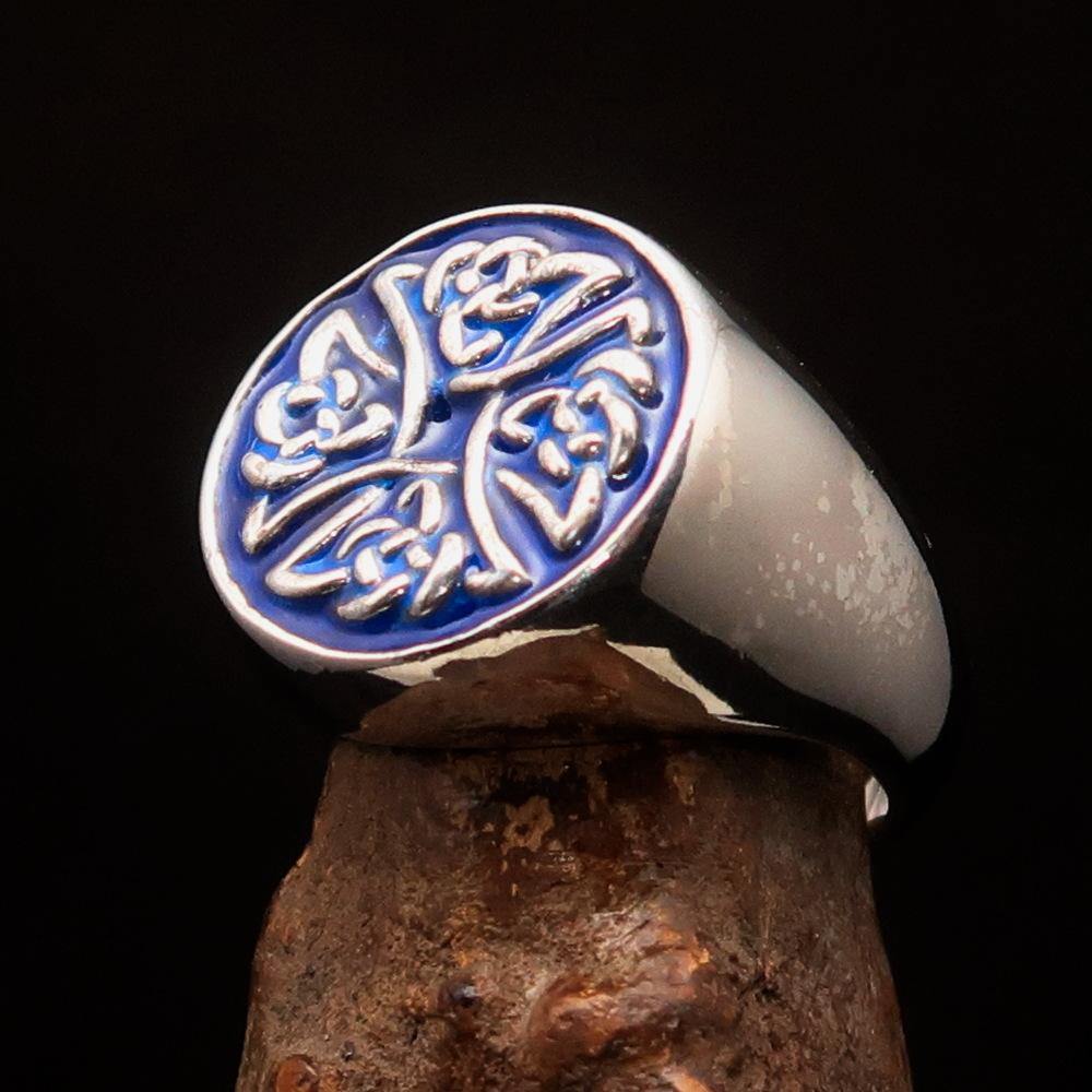 Men's sterling silver ring featuring Celtic Birgit's Cross design with blue enamel, showcasing intricate craftsmanship and high polish.