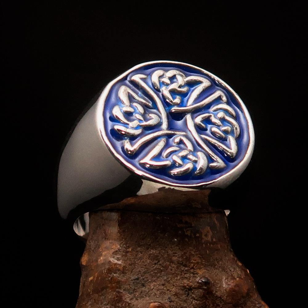 Men's sterling silver ring featuring Celtic Birgit's Cross design with blue enamel, showcasing intricate craftsmanship and high polish.