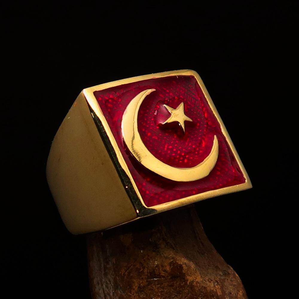 Men's ring made of solid brass featuring a crescent moon and star design with red enamel finish, showcasing its polished surface.