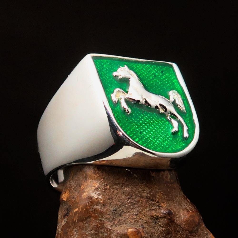 A beautifully crafted sterling silver men's ring featuring a horse coat of arms design with green enamel accents, symbolizing strength and elegance.