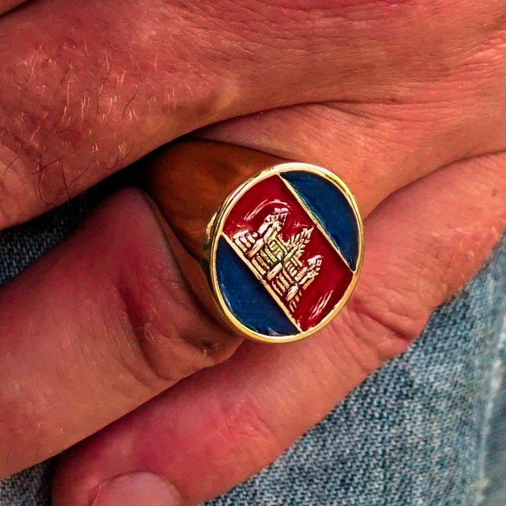 Men's round flag ring made of solid brass with blue and red enamel, showcasing a polished finish and unique design.