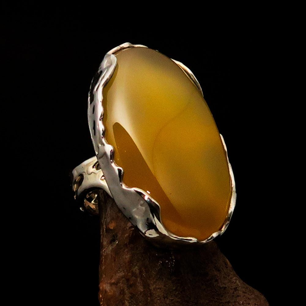 Sterling Silver Artwork Ring featuring an oval yellow Agate Cabochon, polished to a mirror finish, showcasing its vibrant color and elegant design.