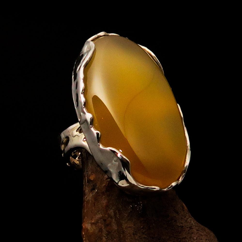 Sterling Silver Artwork Ring featuring an oval yellow Agate Cabochon, polished to a mirror finish, showcasing its vibrant color and elegant design.