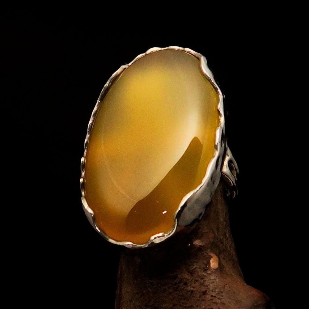 Sterling Silver Artwork Ring featuring an oval yellow Agate Cabochon, polished to a mirror finish, showcasing its vibrant color and elegant design.