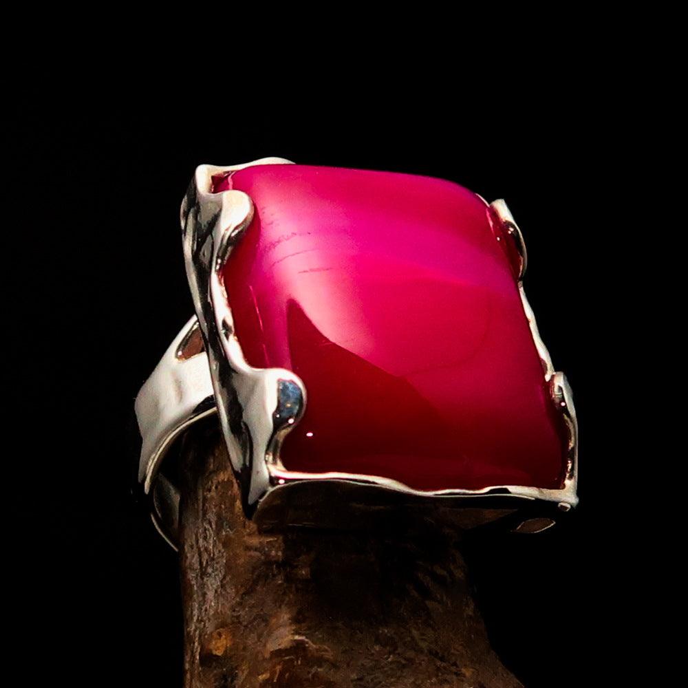 A beautifully crafted Sterling Silver Ring featuring a rectangle-shaped pink Agate Cabochon, showcasing its polished finish and vibrant color.