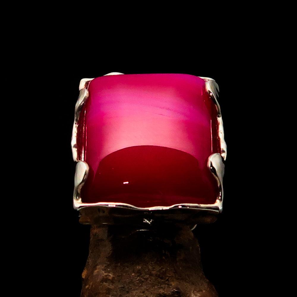 A beautifully crafted Sterling Silver Ring featuring a rectangle-shaped pink Agate Cabochon, showcasing its polished finish and vibrant color.