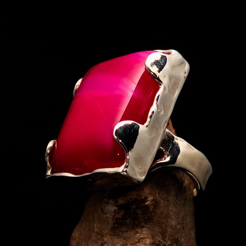 A beautifully crafted Sterling Silver Ring featuring a rectangle-shaped pink Agate Cabochon, showcasing its polished finish and vibrant color.