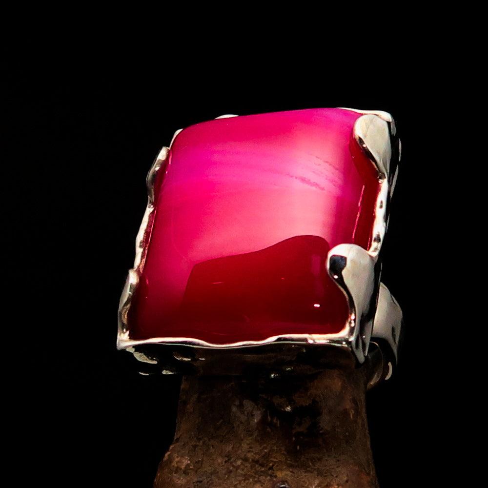 A beautifully crafted Sterling Silver Ring featuring a rectangle-shaped pink Agate Cabochon, showcasing its polished finish and vibrant color.