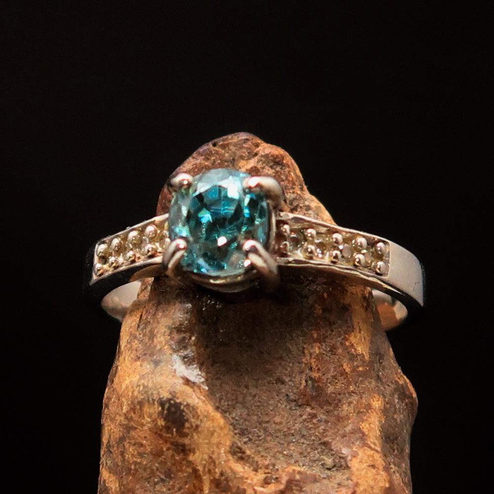 Sterling Silver Solitaire Band Ring featuring an oval cut blue Zircon and 8 white CZ stones, hallmarked 925.