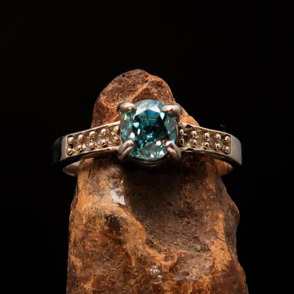 Sterling Silver Solitaire Band Ring featuring an oval cut blue Zircon and 8 white CZ stones, hallmarked 925.