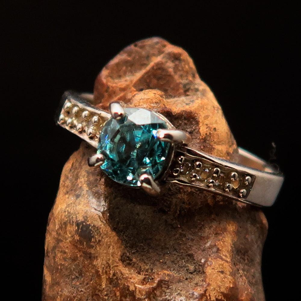 Sterling Silver Solitaire Band Ring featuring an oval cut blue Zircon and 8 white CZ stones, hallmarked 925.