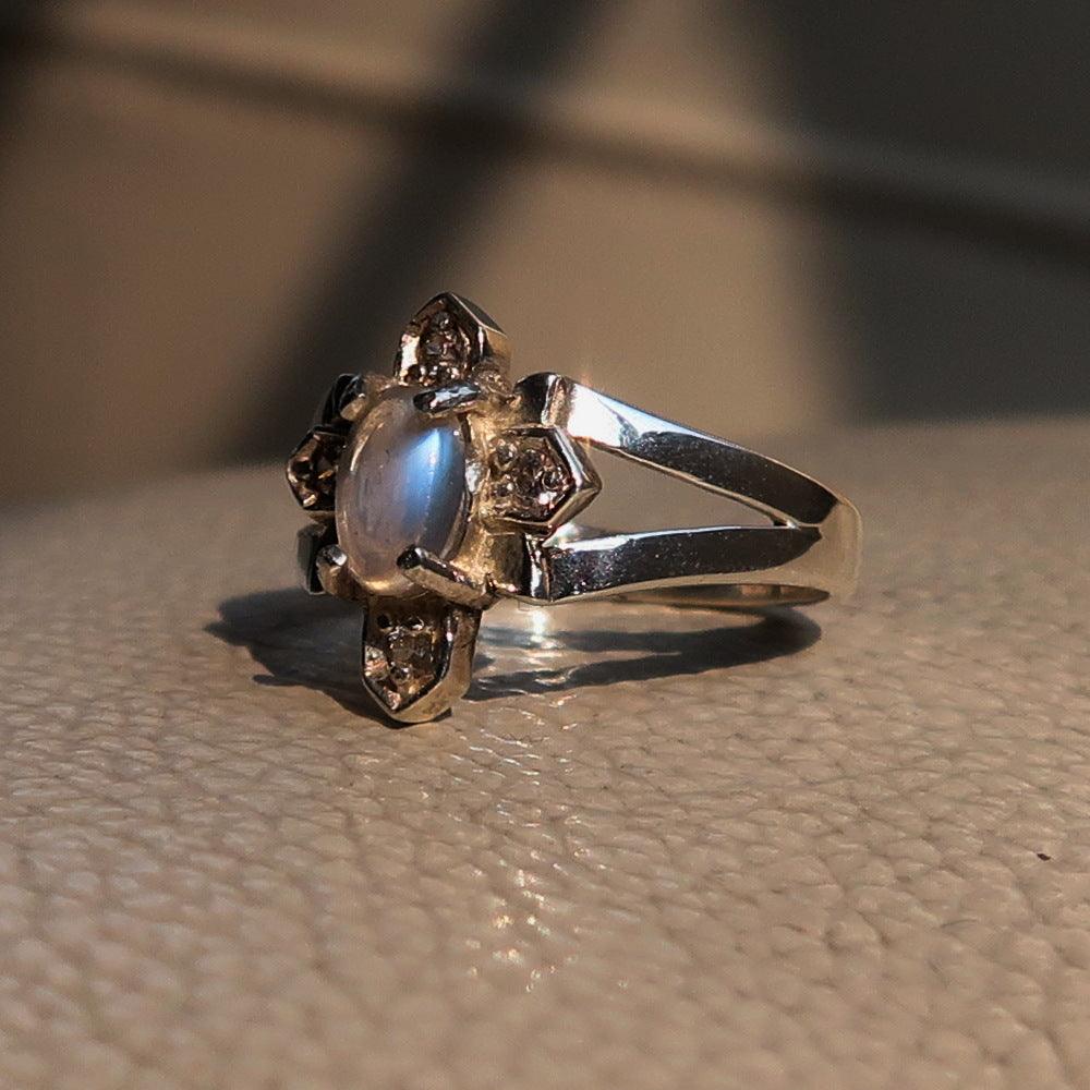 Sterling Silver Solitaire Cross Ring featuring an oval Moonstone, hallmarked 925, showcasing its elegant design and polished finish.