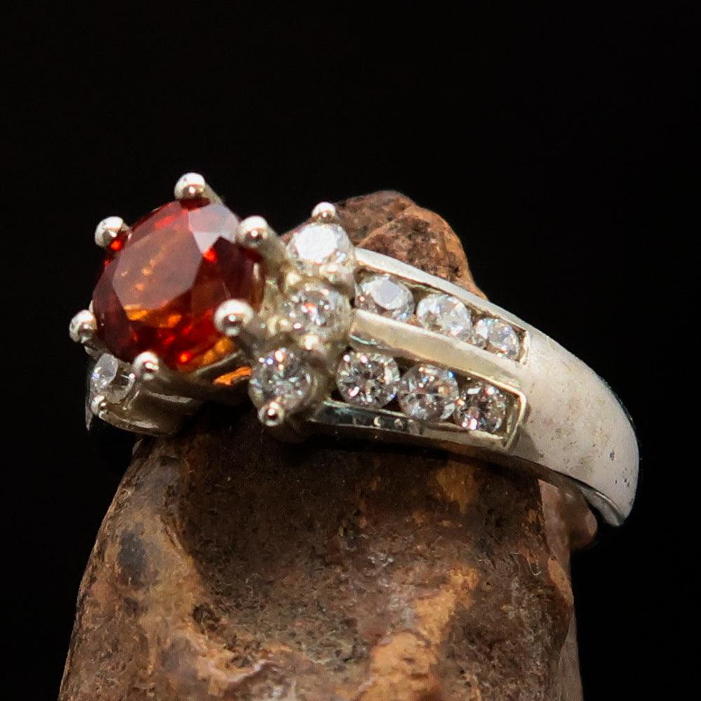 Sterling Silver Solitaire Ring featuring a round cut orange Sapphire and 18 white Cubic Zirconia stones, size 6.5.