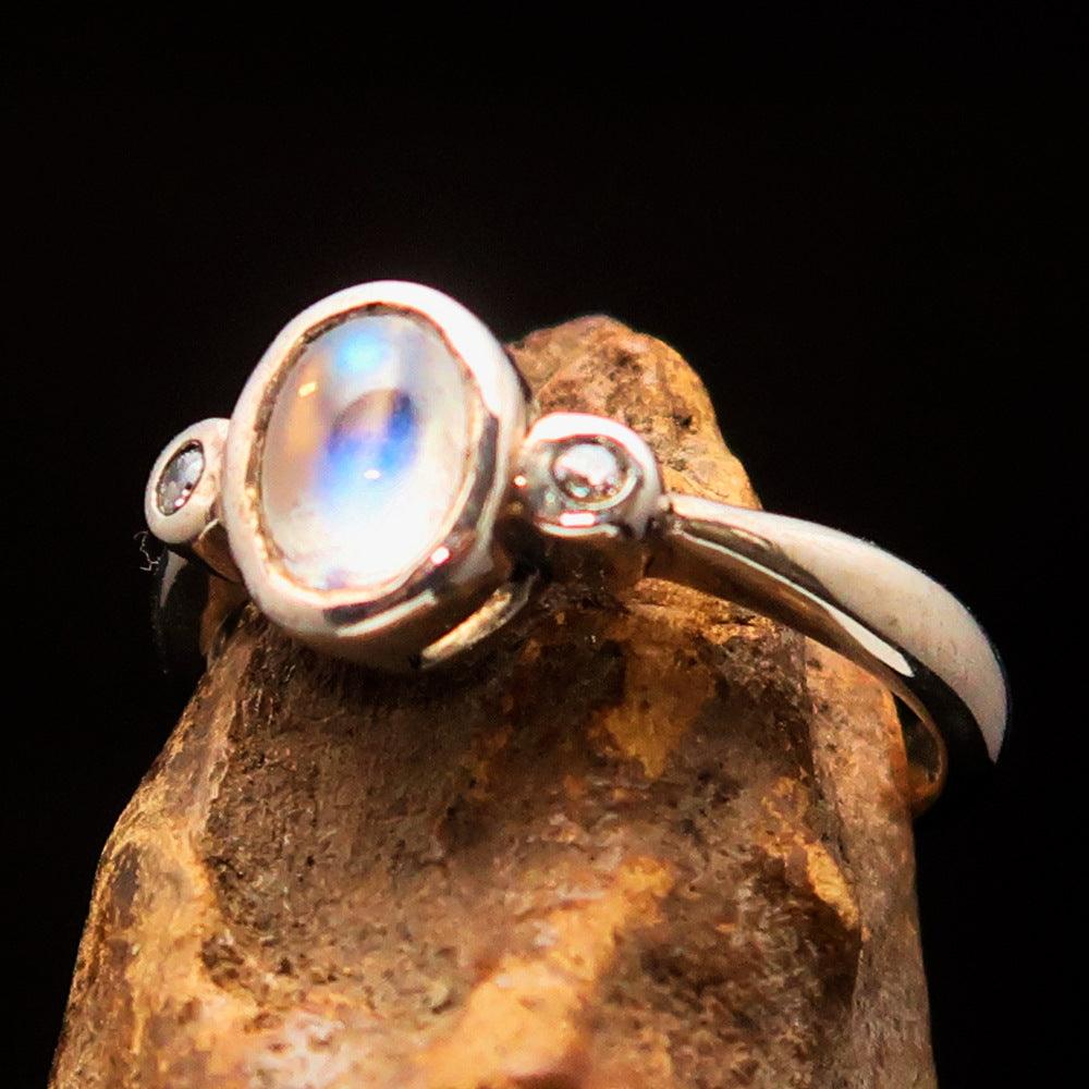 Sterling Silver Solitaire Ring featuring an oval Ceylon Moonstone, polished to a mirror finish, showcasing its elegant design.