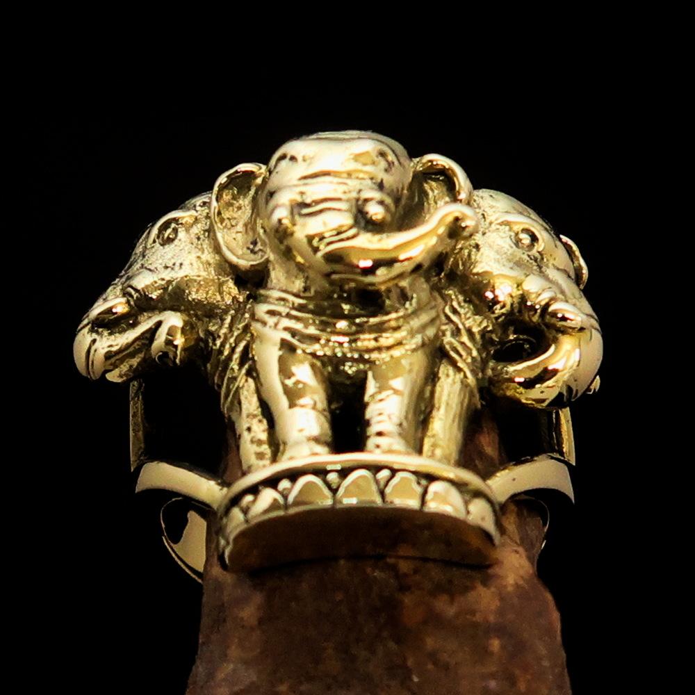 A stunning men's brass ring featuring an intricately designed three-headed elephant, showcasing its polished and antiqued finish.