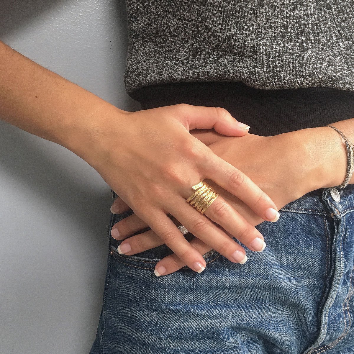 A stunning Swirling Ring featuring a unique spiral design, crafted from pewter with gold or silver plating, showcasing its artistic beauty.