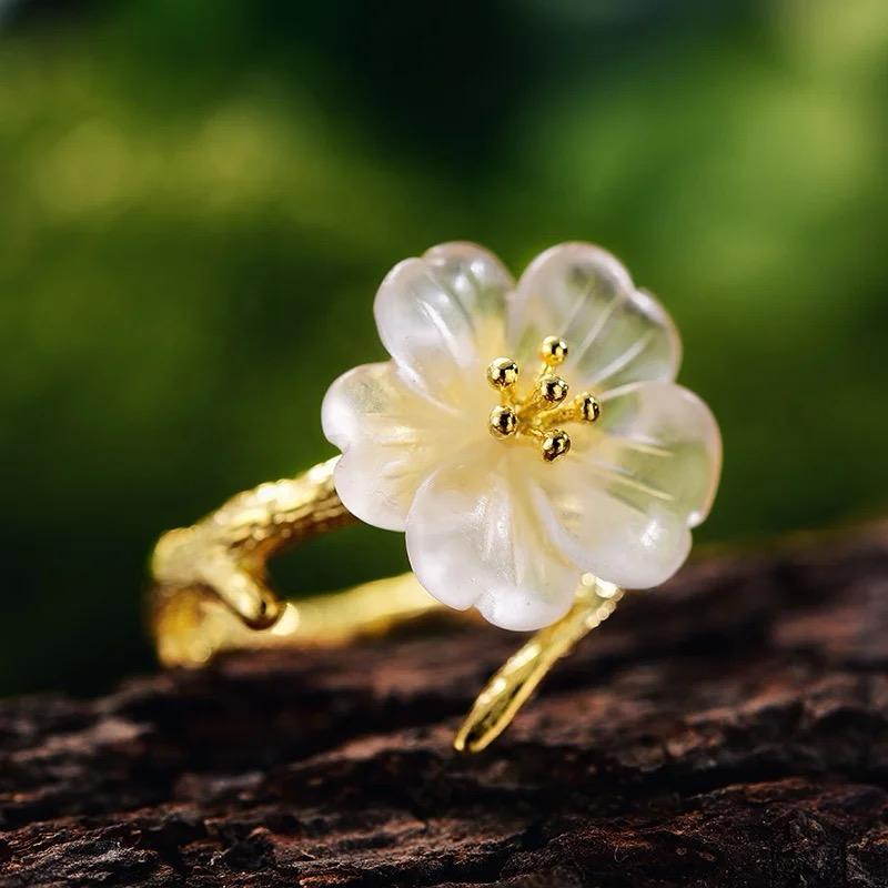 Sylvan Blossom Ring featuring a delicate flower design in 925 sterling silver with an 18K gold-plated leaf.