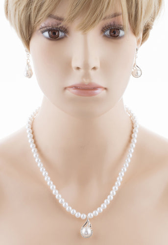 Bridal wedding jewelry set featuring a silver necklace with clear Austrian crystals and white faux pearls, accompanied by matching earrings.