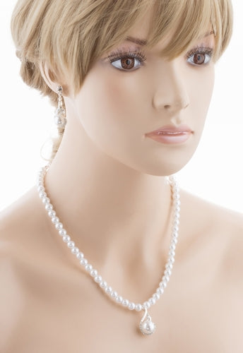 Bridal wedding jewelry set featuring a silver necklace with clear Austrian crystals and white faux pearls, accompanied by matching earrings.