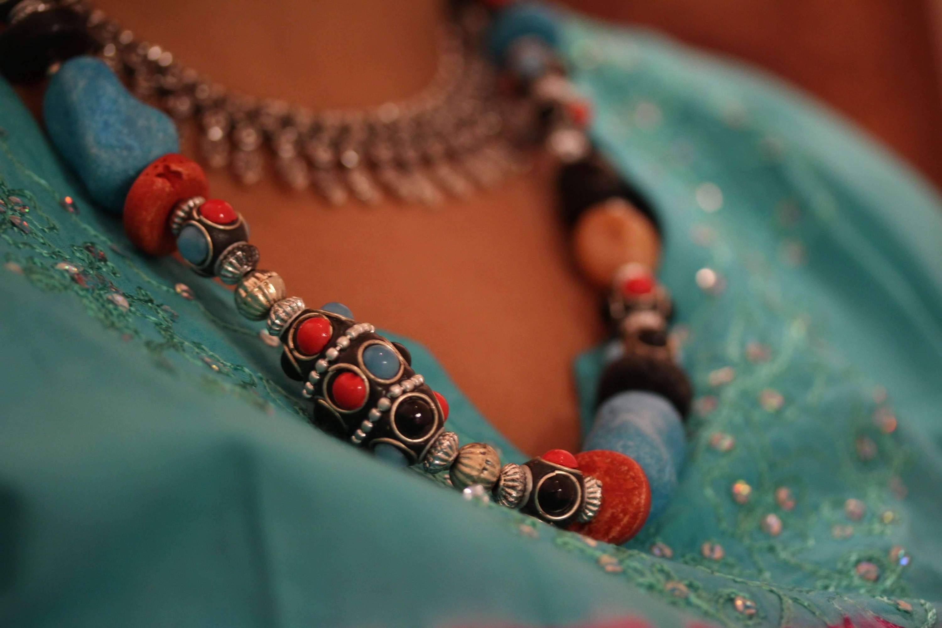 Eastern Flare Resin Beads & Charms Necklace featuring vibrant turquoise and coral red beads, shiny silver tone charms, and matching earrings.