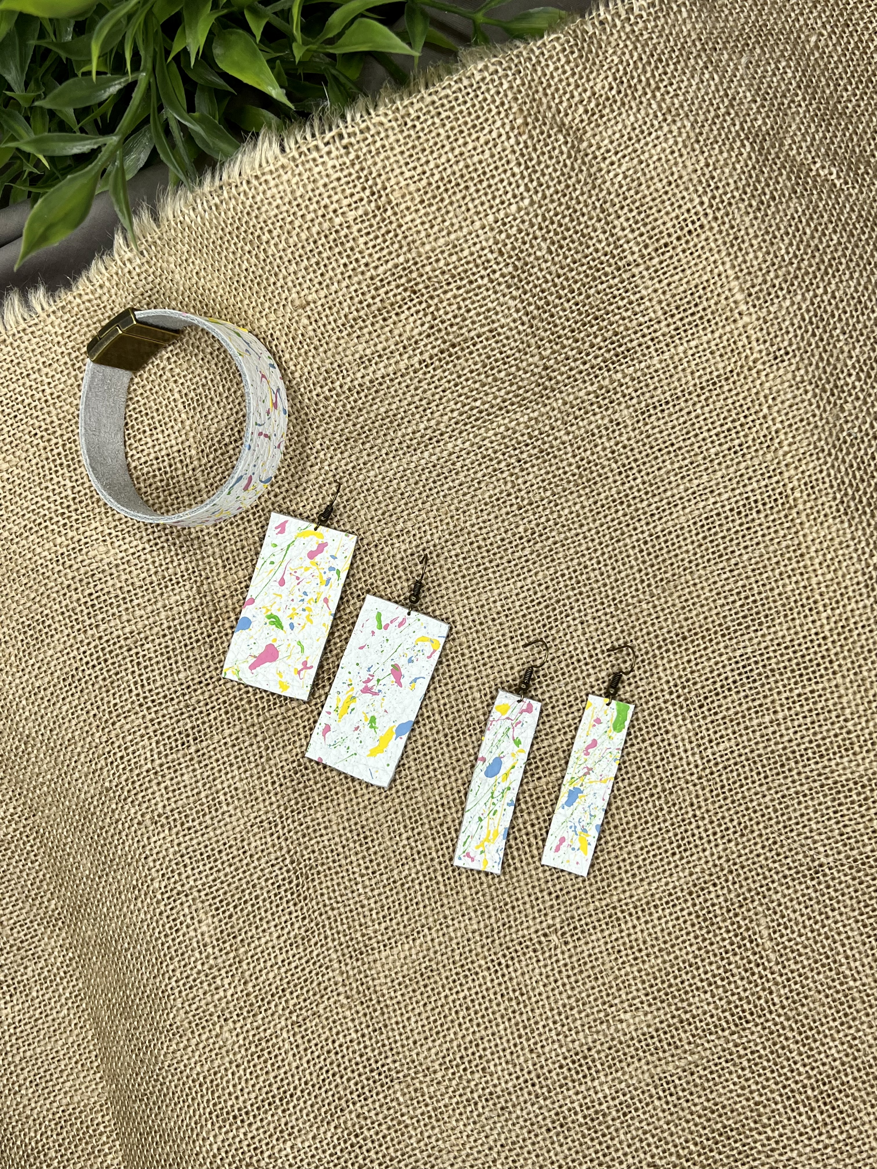 White splatter-painted bracelet and earrings.