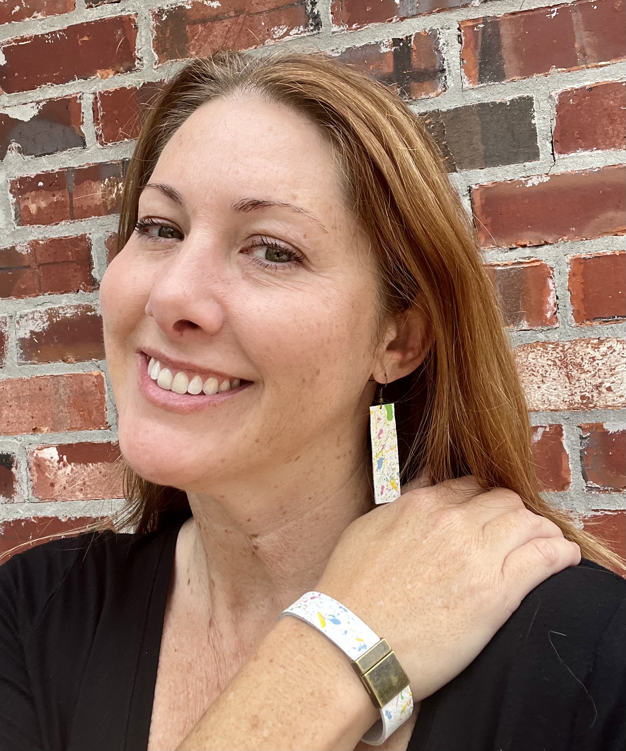 A woman smiling with jewelry