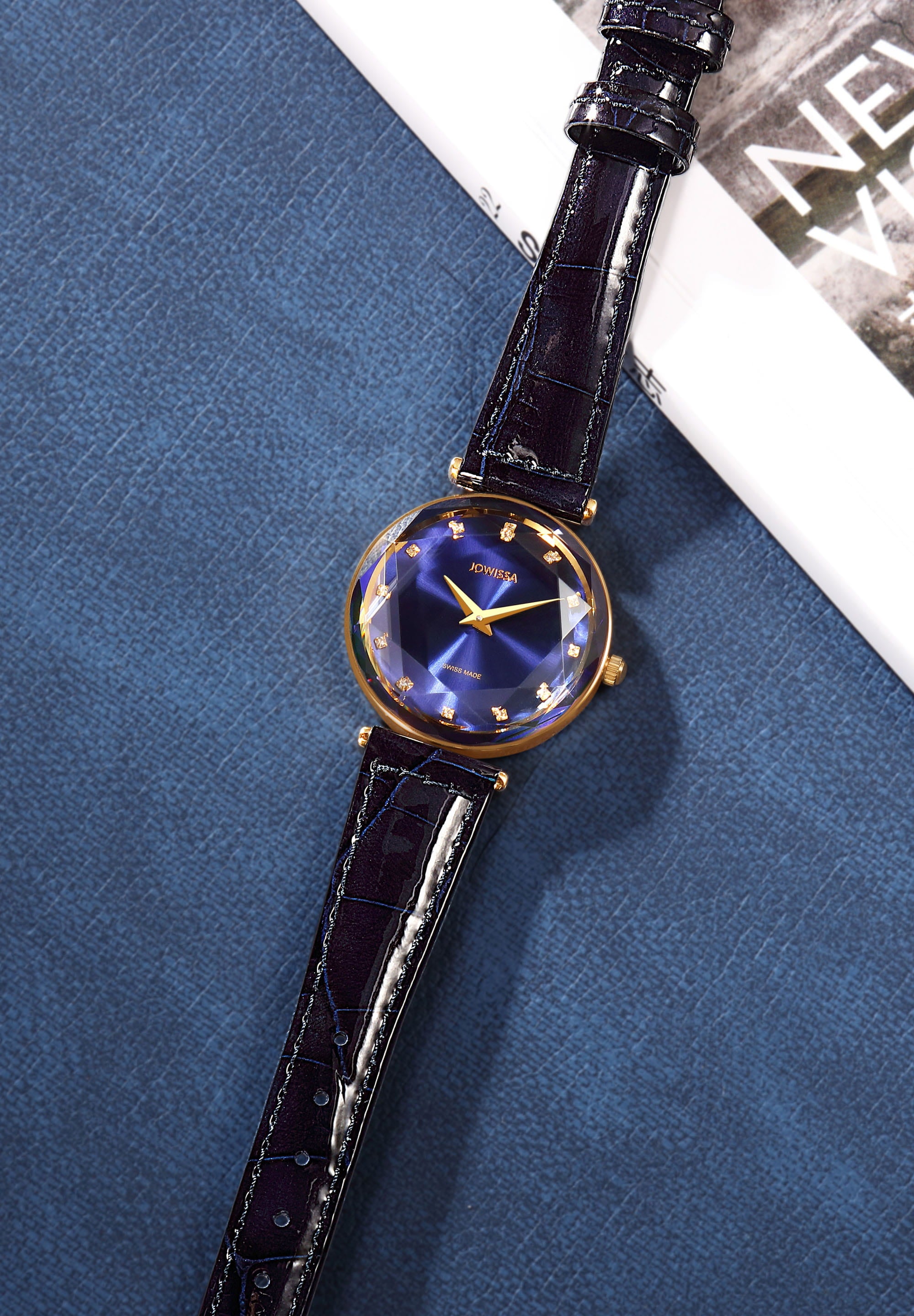 Facet Brilliant Swiss Ladies Watch J5.752.M featuring a royal blue dial, gold-tone details, and a glossy leather strap.