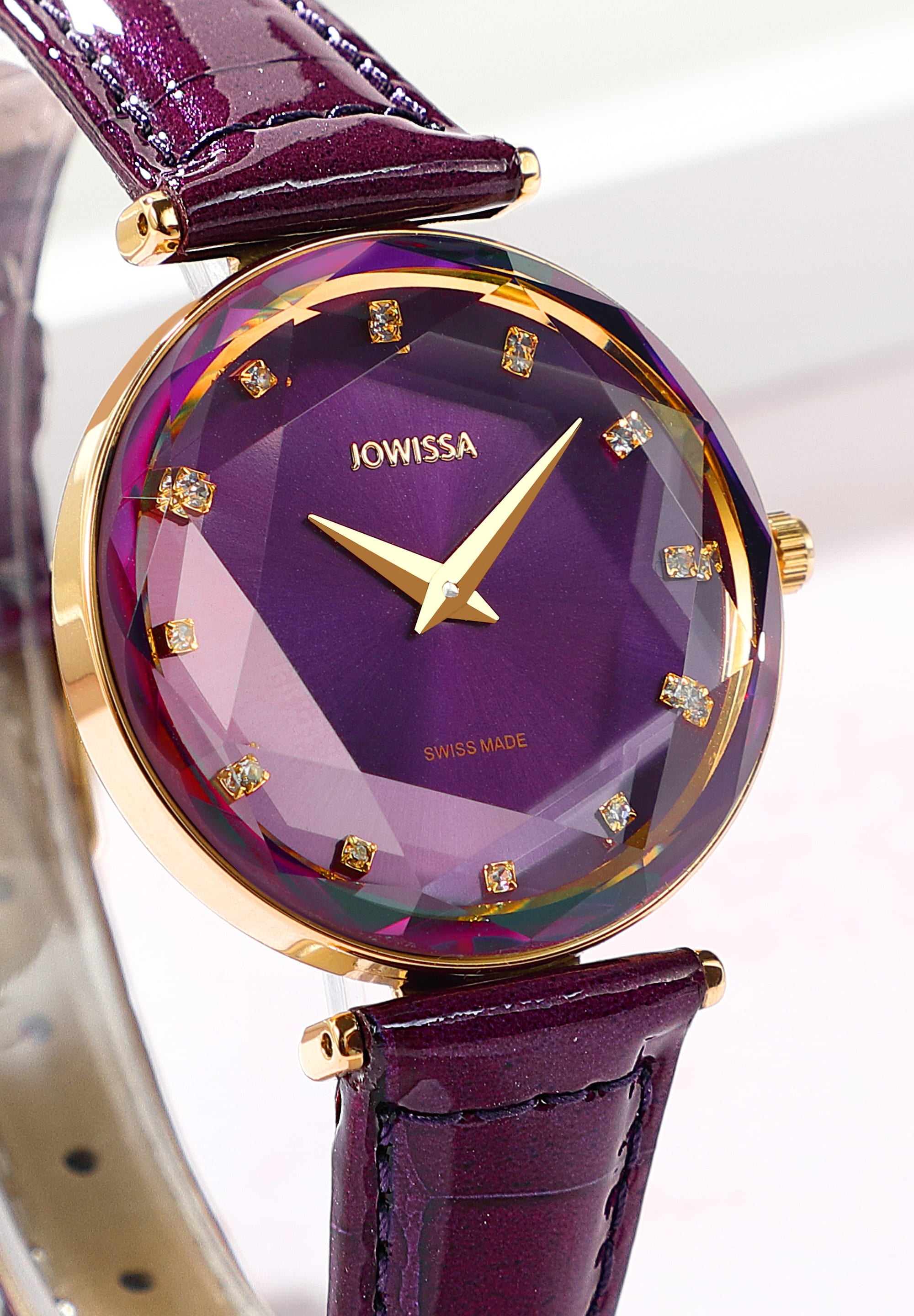 Facet Brilliant Swiss Ladies Watch J5.831.M with purple leather strap and sparkling rhinestones on the dial, showcasing elegant design and Swiss craftsmanship.