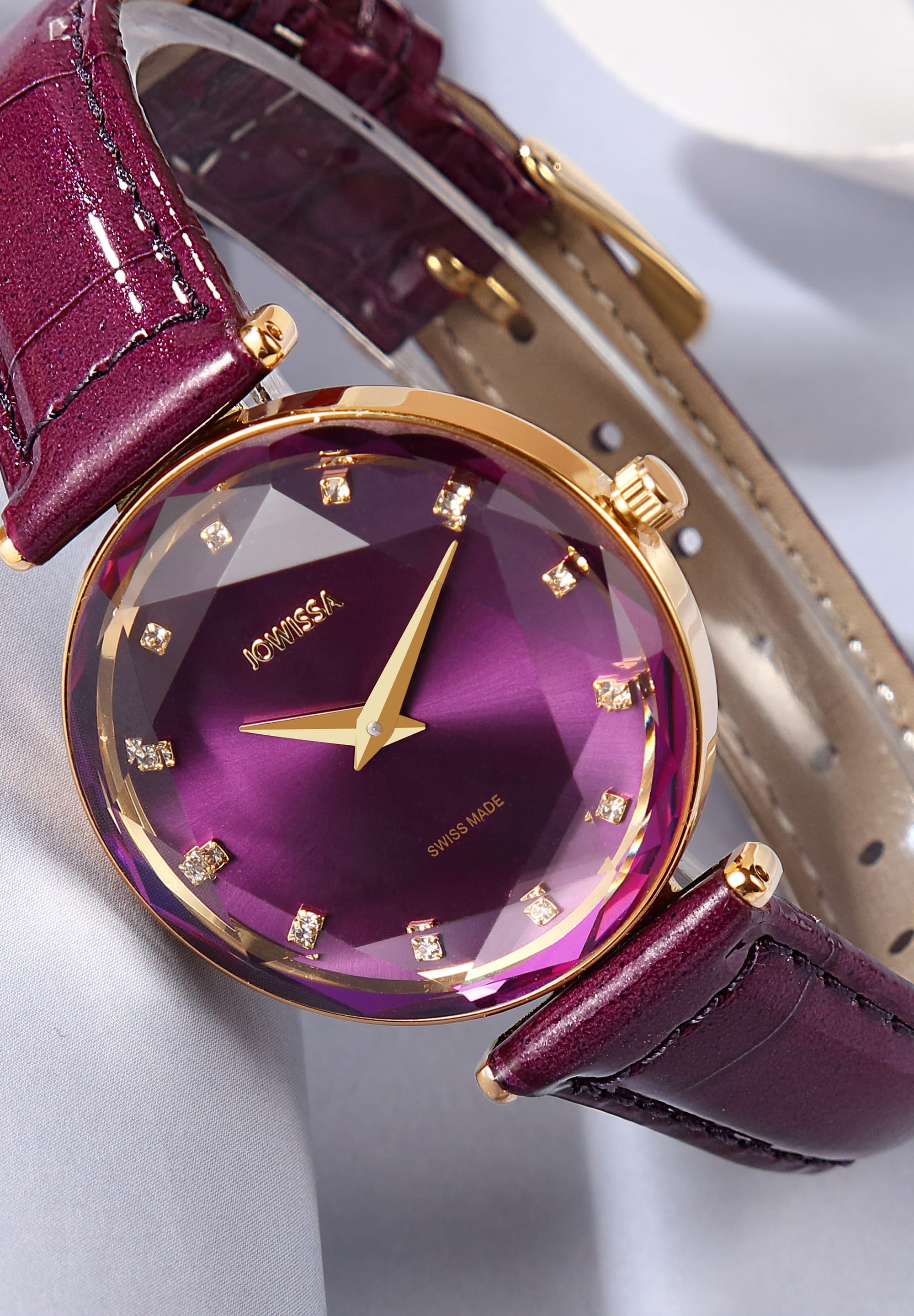 Facet Brilliant Swiss Ladies Watch J5.831.M with purple leather strap and sparkling rhinestones on the dial, showcasing elegant design and Swiss craftsmanship.