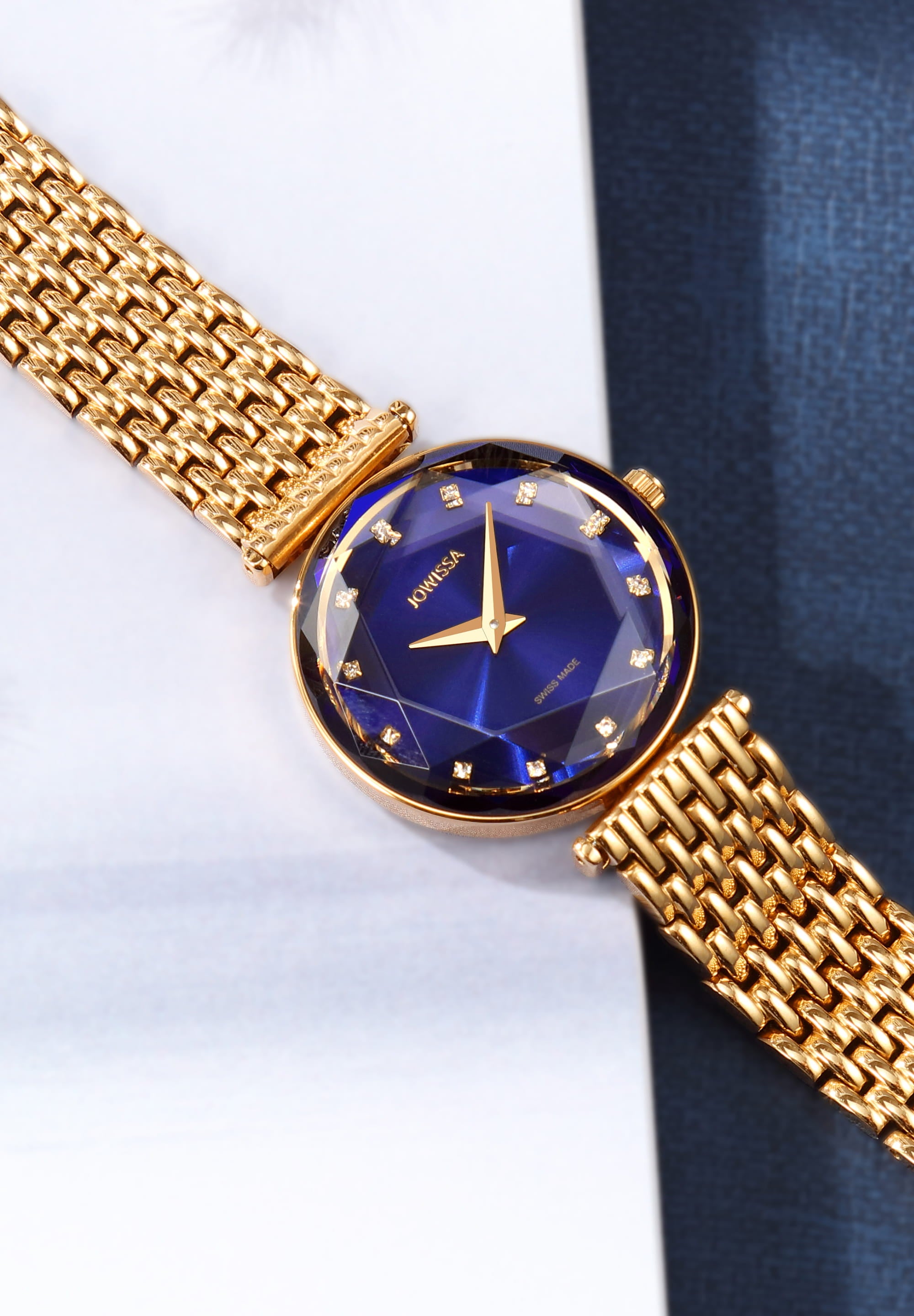 Facet Brilliant Swiss Ladies Watch J5.842.M featuring a blue dial, gold stainless steel bracelet, and sparkling mineral glass.