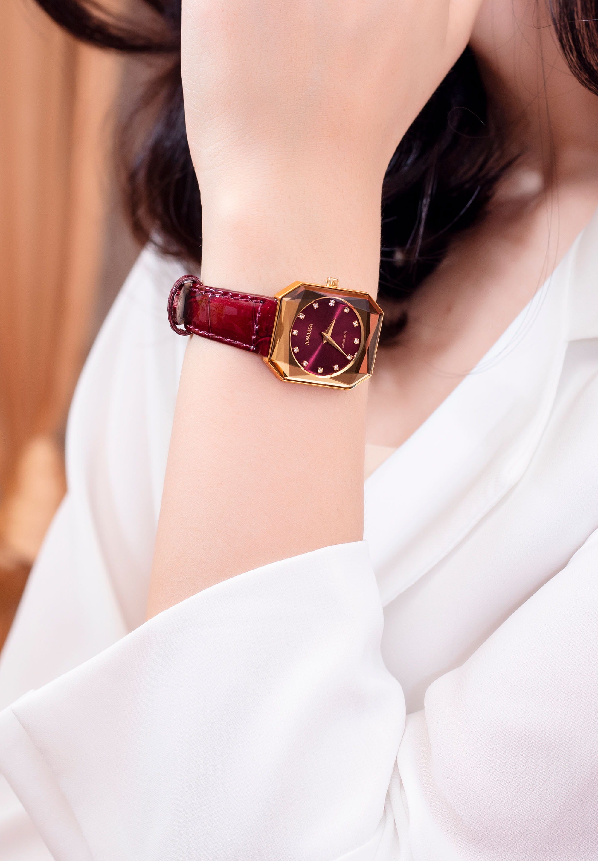 Facet Radiant Swiss Ladies Watch J8.076.M featuring a gold case, burgundy dial, and glossy leather strap, showcasing elegance and luxury.