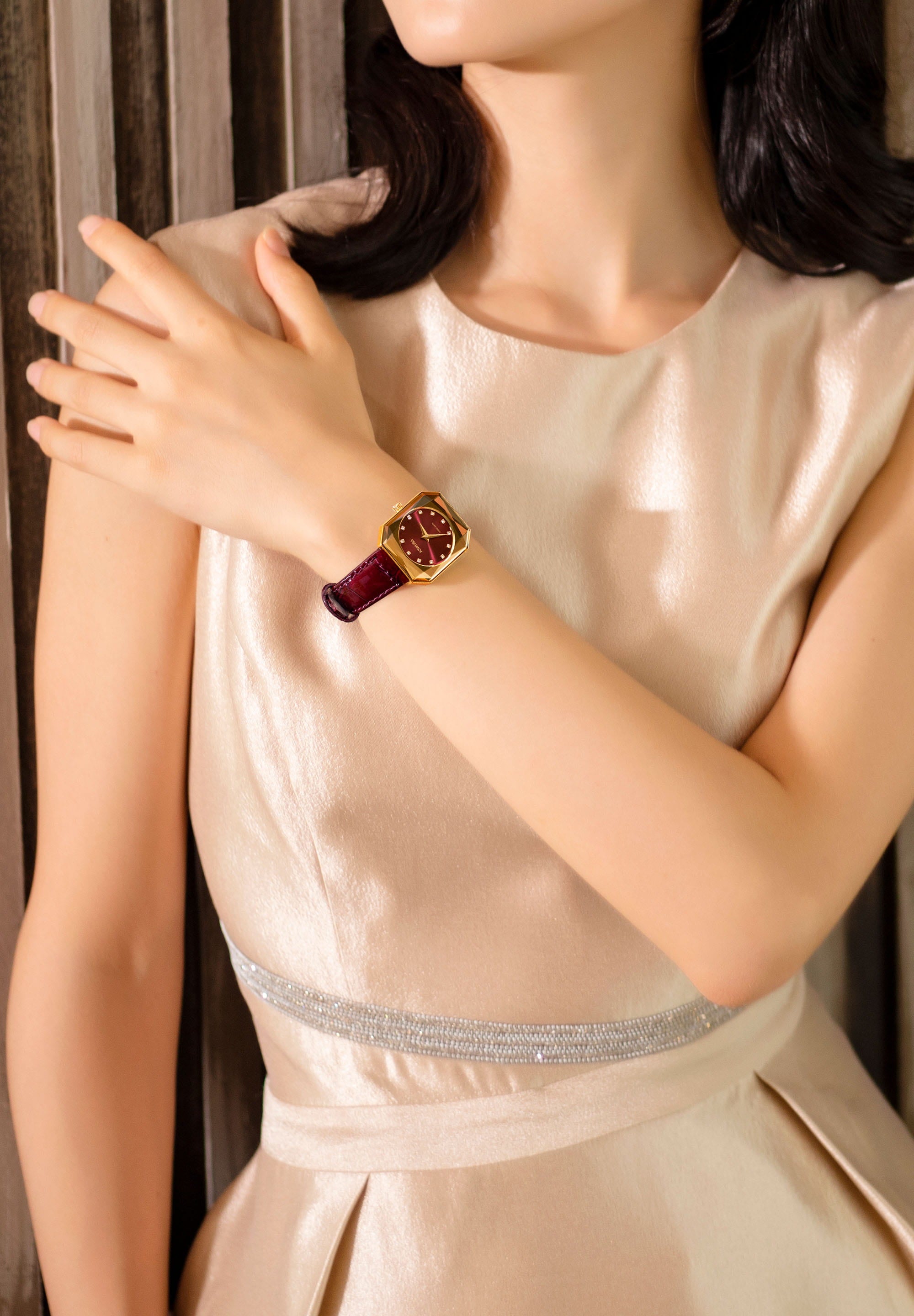 Facet Radiant Swiss Ladies Watch J8.076.M featuring a gold case, burgundy dial, and glossy leather strap, showcasing elegance and luxury.